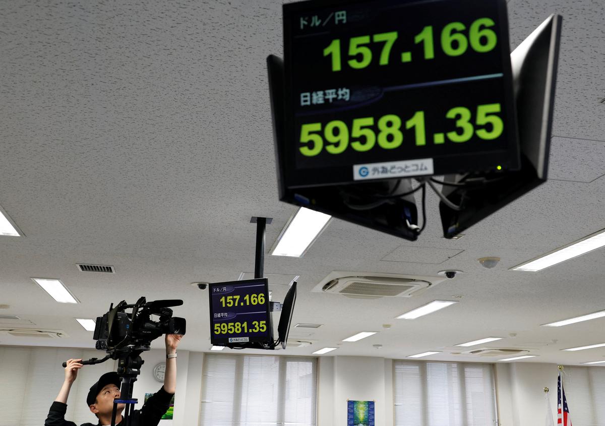A TV cameraman films a monitor displaying the current Japanese yen exchange rate against the U.S. dollar and Nikkei share average at a dealing room of the foreign exchange trading company Gaitame.com in Tokyo, Japan May 1, 2026. REUTERS/Kim Kyung-Hoon