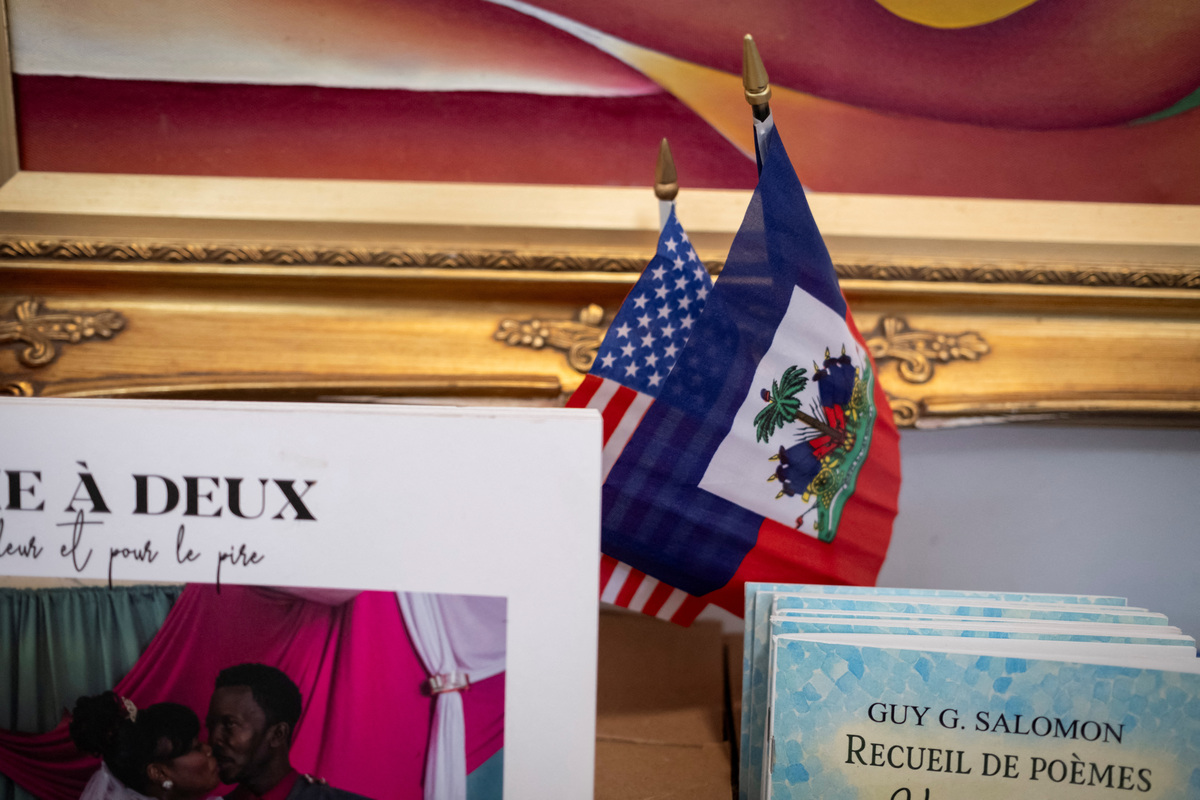 Haitian and U.S. flags sit at a bookstore in the Little Haiti neighborhood in Miami, Florida, U.S., June 26, 2026. REUTERS/Marco Bello