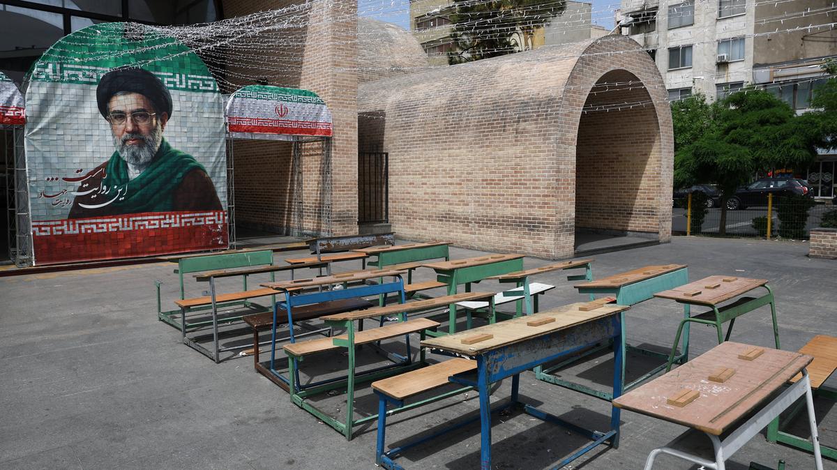 A banner with a picture of Iran's new Supreme Leader, Mojtaba Khamenei, next to a symbolic classroom of the Minab school students who were killed in a strike, in Tehran, Iran, May 8, 2026. Majid Asgaripour/WANA (West Asia News Agency) via REUTERS