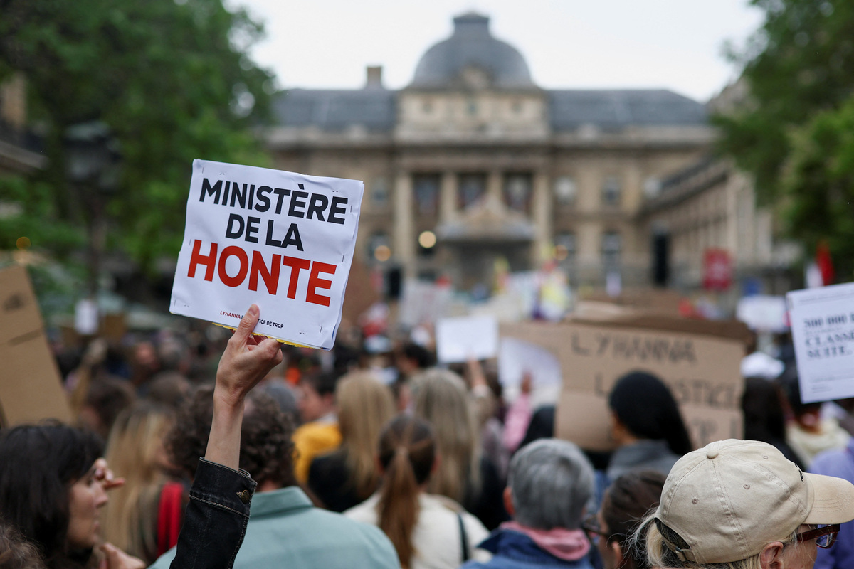 People attend a demonstration, amid nationwide calls to protest the handling by the criminal justice system of previous complaints involving child victims against the main suspect in the killing of 11-year-old Lyhanna, whose body was discovered near Fleurance after a days-long search, near the  Paris courthouse, France, June 8, 2026, in a protest supported by the #NousToutes movement. The sign reads: "Ministry of shame". REUTERS/Gonzalo Fuentes
