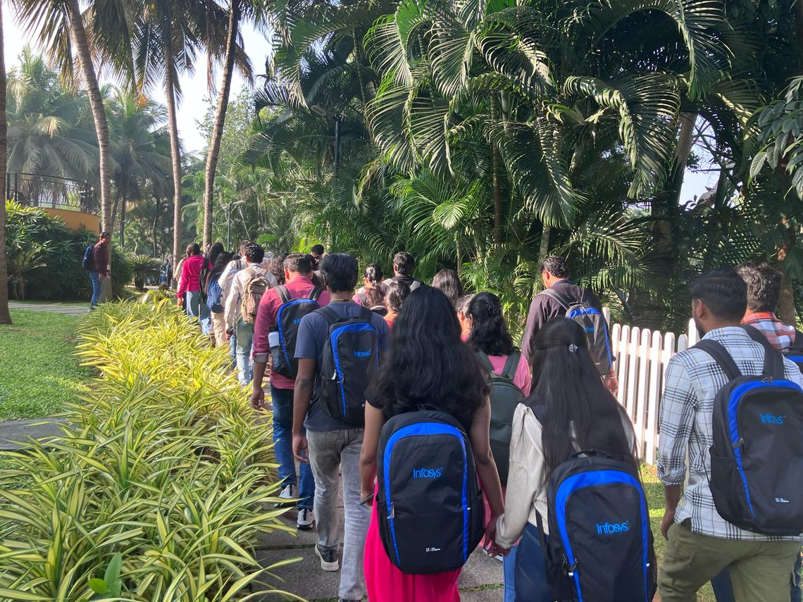  Every weekday, trainees stream from their dorms to classes, which start at 9:15 a.m. Credit: Ben Wildavsky