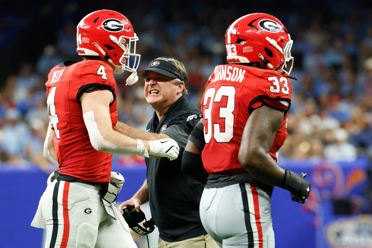  Jan 1, 2026; New Orleans, LA, USA; Georgia Bulldogs head coach Kirby Smart congratulates tight end Oscar Delp (4) and linebacker Quintavius Johnson (33) after a play against the Mississippi Rebels in the second quarter during the 2025 Sugar Bowl and quarterfinal game of the College Football Playoff at Caesars Superdome. Mandatory Credit: Amber Searls-Imagn Images 