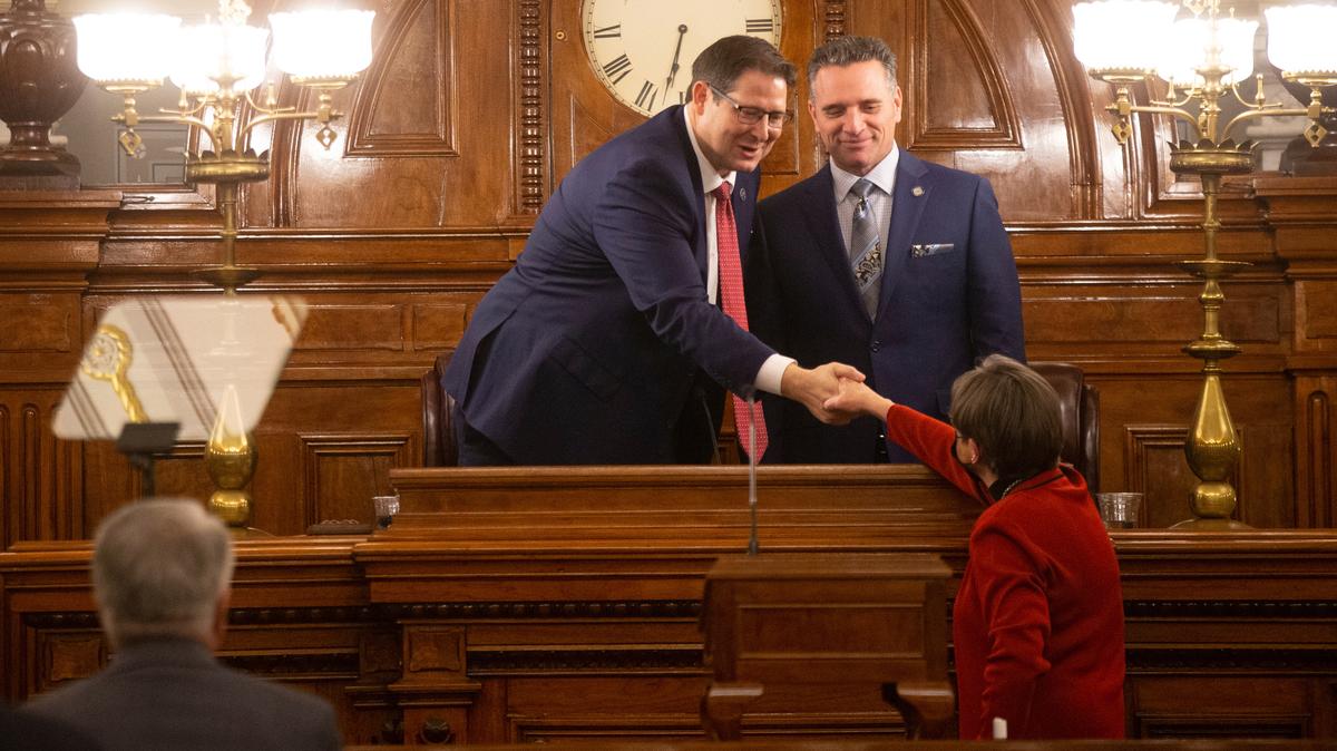 Gov. Laura Kelly shakes hands with House Speaker Ron Ryckman, R-Olathe, and Senate President Ty Masterson, R-Andover, before the start of the annual State of the State, on Jan. 11 in Topeka.