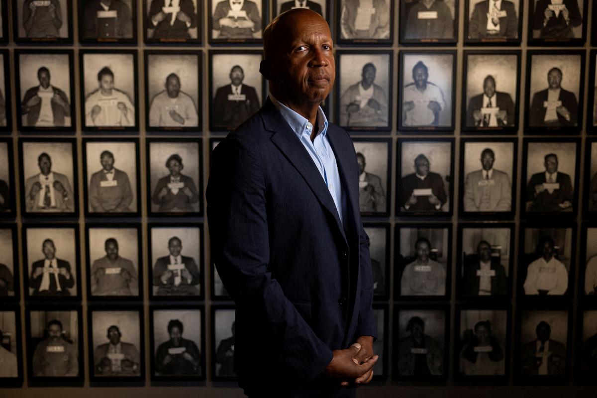 Bryan Stevenson, founder of the Equal Justice Initiative, stands for a portrait in front of an exhibit that features the arrest photographs of individuals who participated in the 1955 Montgomery bus boycott, a key moment the Civil Rights Movement in America, in Montgomery, Alabama, U.S., May 6, 2026.  REUTERS/Kevin Mohatt     TPX IMAGES OF THE DAY