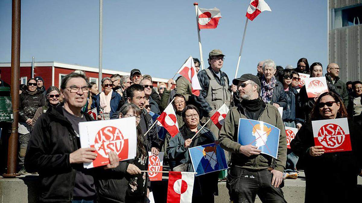 Protestors with placards which read USA and ASU (’Stop It’ in Greenlandic) as they demonstrate against the new U.S. consulate in Nuuk, Greenland, on Thursday. The diplomatic hub’s opening was met by demonstrators opposed to President Donald Trump’s ambition for greater influence in the Arctic island.