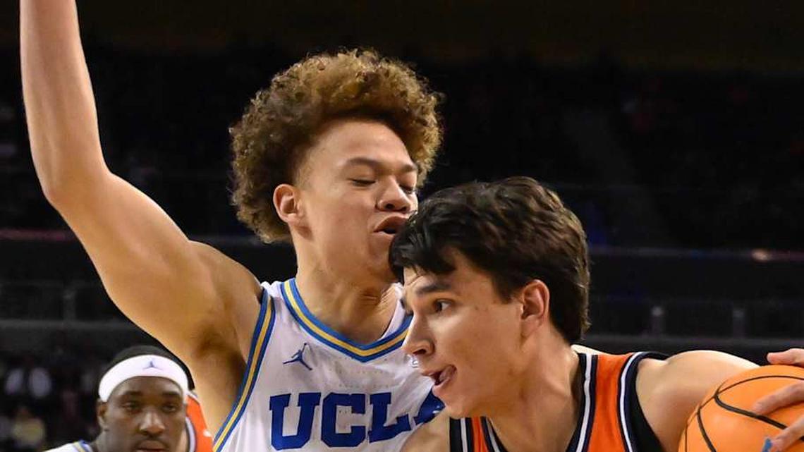  Feb 21, 2026; Los Angeles, California, USA; Illinois guard Andrej Stojakovic (2) drives the baseline as UCLA guard Trent Perry (0) moves in to defend during the 2nd half at Pauley Pavilion presented by Wescom Financial. Mandatory Credit: Robert Hanashiro-Imagn Images | Robert Hanashiro-Imagn Images 