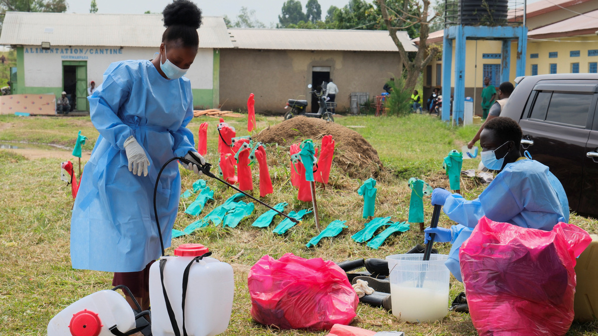 Medical workers dressed in personal protective equipment (PPE) disinfect their equipment at an Ebola treatment centre during a ceremony to present recovery certificates to patients at the Rwambara General Reference Hospital in Bunia, eastern Democratic Republic of Congo, June 16, 2026. REUTERS/Gradel Muyisa Mumbere