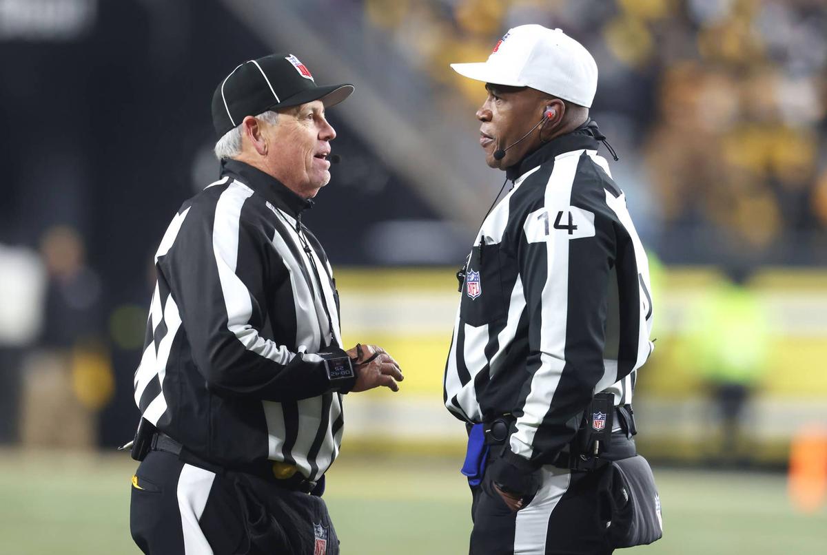  Jan 4, 2026; Pittsburgh, Pennsylvania, USA; NFL line judge Jeff Seeman (left) and referee Shawn Smith (14) discuss a call during the fourth quarter between the Baltimore Ravens and the Pittsburgh Steelers at Acrisure Stadium. Mandatory Credit: Charles LeClaire-Imagn Images 