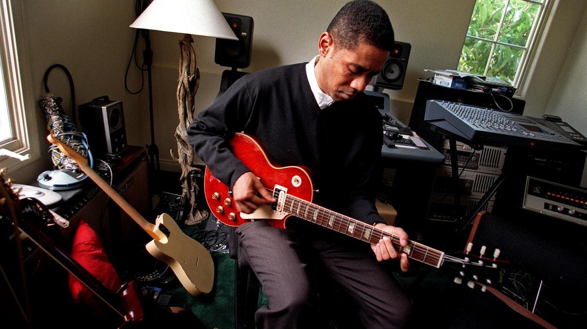 MALIBU, CALIF. -- MAR. 20, 1998 -- A&M music executive John McClain takes time to play his guitar at his house in Malibu. McClain was hired by the company to kick start the black music division. (Wally Skalij / Los Angeles Times)
