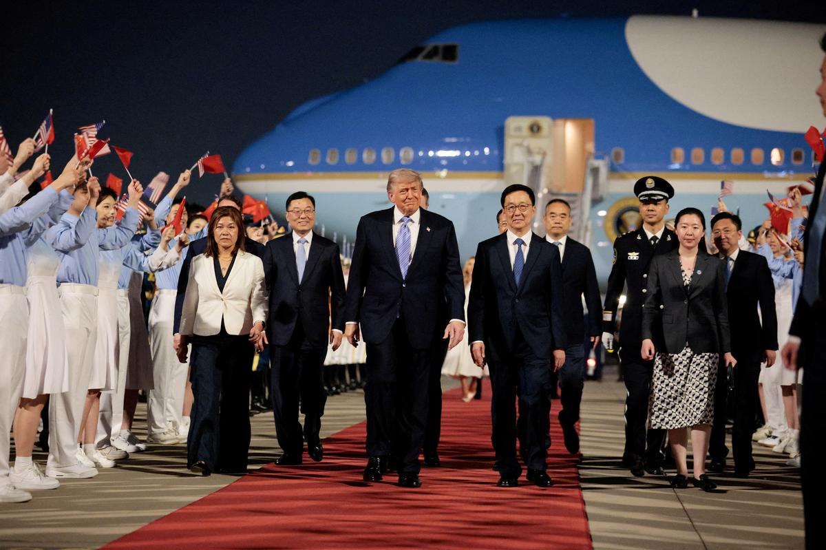 U.S. President Donald Trump walks with Chinese Vice President Han Zheng during an arrival ceremony at Beijing Capital International Airport, in Beijing, China, May 13, 2026. REUTERS/Evan Vucci