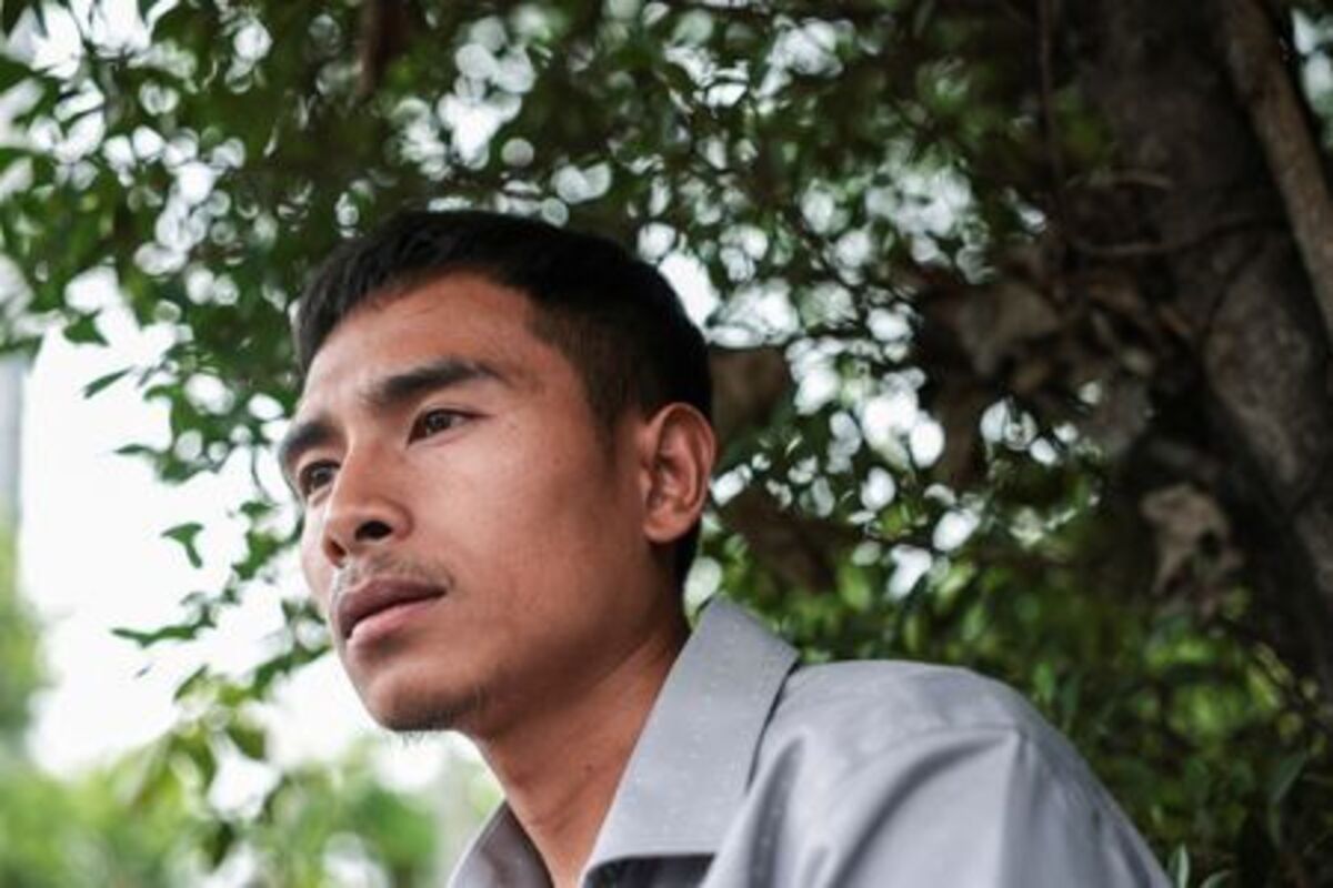 Noppadon Wongsuvan, 33, a Thai crew member of the cargo ship Mayuree Naree that was struck on March 11, killing three crew members, while sailing through the Strait of Hormuz, looks on during an interview with Reuters after the Central Labour Court accepts a lawsuit accusing Thailand-based company Precious Shipping of ordering the vessel to sail through the waterway despite military tensions between the U.S. and Iran, in Bangkok, Thailand, July 10, 2026. REUTERS/Chalinee Thirasupa
