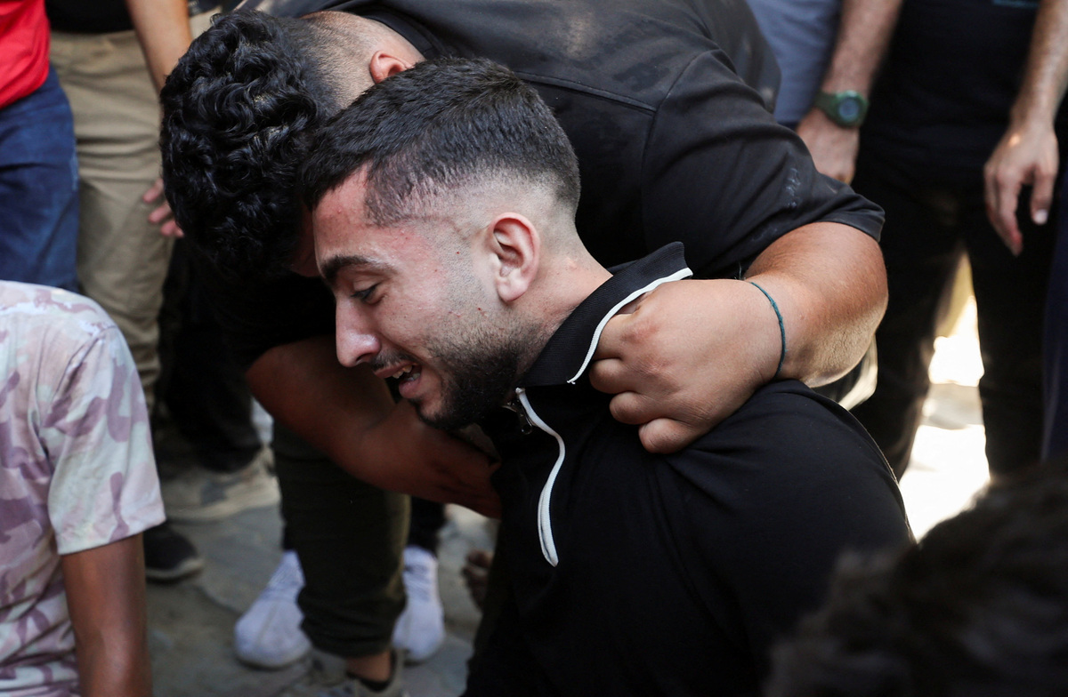 A mourner reacts during the funeral of six Palestinian police officers who were killed in an Israeli strike on a police station, according to medics, at Al Shifa Hospital in Gaza City, July 14, 2026. REUTERS/Dawoud Abu Alkas