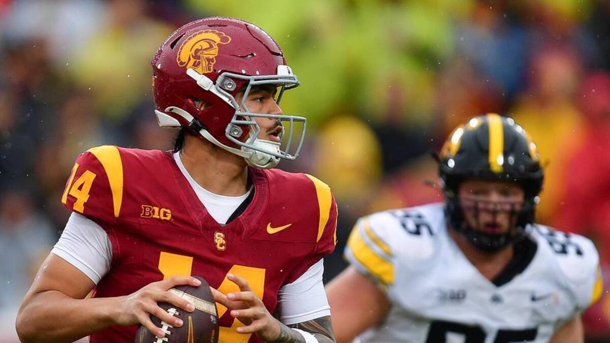  Nov 15, 2025; Los Angeles, California, USA; Southern California Trojans quarterback Jayden Maiava (14) moves out to pass against the Iowa Hawkeyes during the first half at the Los Angeles Memorial Coliseum. Mandatory Credit: Gary A. Vasquez-Imagn Images | Gary A. Vasquez-Imagn Images 