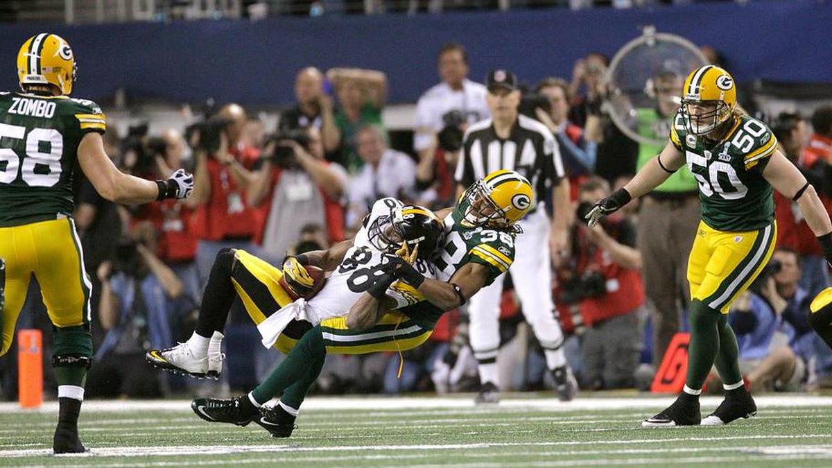 The Green Bay Packers defender Tramon Williams (38) pulls down Pittsburgh Steelers wide receiver Emmanuel Sanders (88) in the second half of Super Bowl XLV, in Arlington, Texas, Sunday, February 6, 2011. Packers Frank Zombo (58) and A.J. Hawk (50) look on. | Mark Hoffman / Milwaukee Journal Sentinel / USA TODAY NETWORK via Imagn Images 