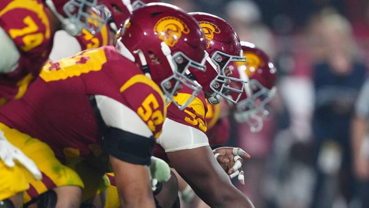  Nov 29, 2025; Los Angeles, California, USA; Helmets at the line of scrimmage as Southern California Trojans offensive lineman J'Onre Reed (50) snaps the ball against the UCLA Bruins in the second half at United Airlines Field at Los Angeles Memorial Coliseum. Mandatory Credit: Kirby Lee-Imagn Images | Kirby Lee-Imagn Images 