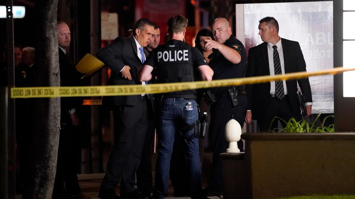 Investigators gather outside an office building where a shooting occurred in Orange, Calif., Wednesday, March 31, 2021.