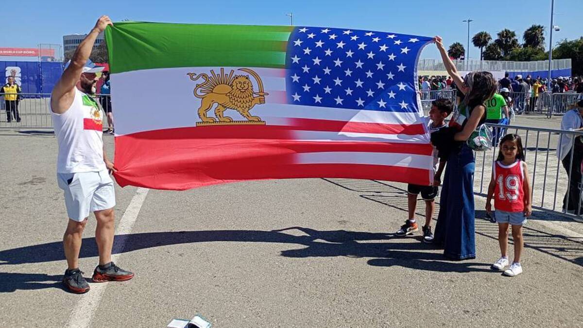  Ramin (left) was not allowed to take in his specially made flag. | Sports Illustrated 