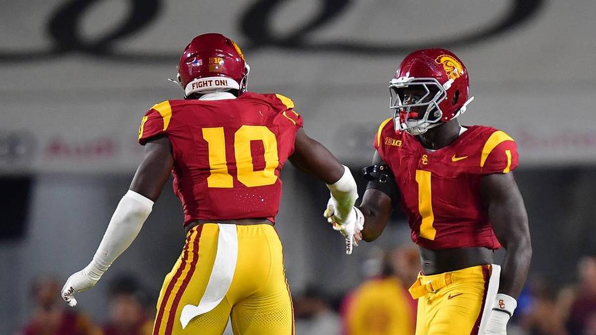  Sep 20, 2025; Los Angeles, California, USA; Southern California Trojans defensive end Braylan Shelby (10) celebrates with defensive end Kameryn Crawford (1) after bringing down Michigan State Spartans quarterback Aidan Chiles (2) during the first half at the Los Angeles Memorial Coliseum. Mandatory Credit: Gary A. Vasquez-Imagn Images | Gary A. Vasquez-Imagn Images 