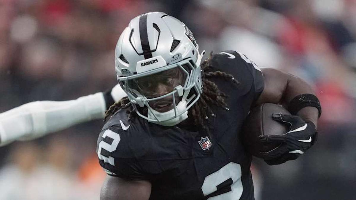  Jan 4, 2026; Paradise, Nevada, USA; Las Vegas Raiders running back Ashton Jeanty (2) carries the ball against Kansas City Chiefs linebacker Drue Tranquill (23) in the first half at Allegiant Stadium. Mandatory Credit: Kirby Lee-Imagn Images | Kirby Lee-Imagn Images 