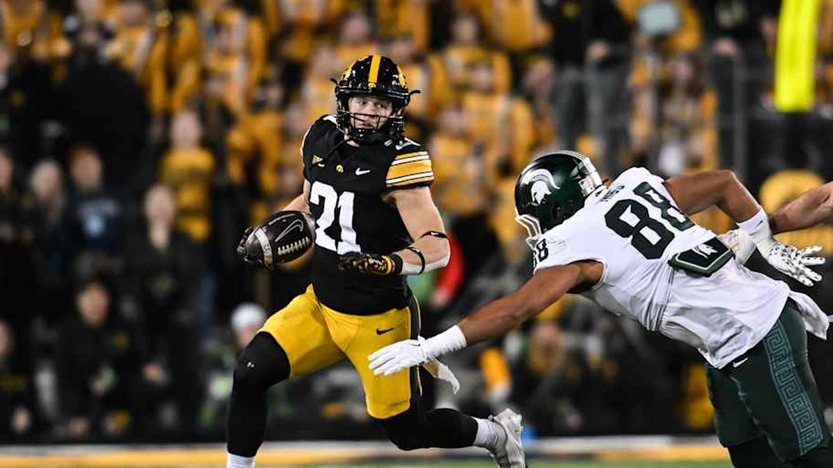  Nov 22, 2025; Iowa City, Iowa, USA; Iowa Hawkeyes wide receiver Kaden Wetjen (21) returns a punt as Michigan State Spartans tight end Kai Rios (88) attempts to make the tackle during the fourth quarter at Kinnick Stadium. Mandatory Credit: Jeffrey Becker-Imagn Images | Jeffrey Becker-Imagn Images 