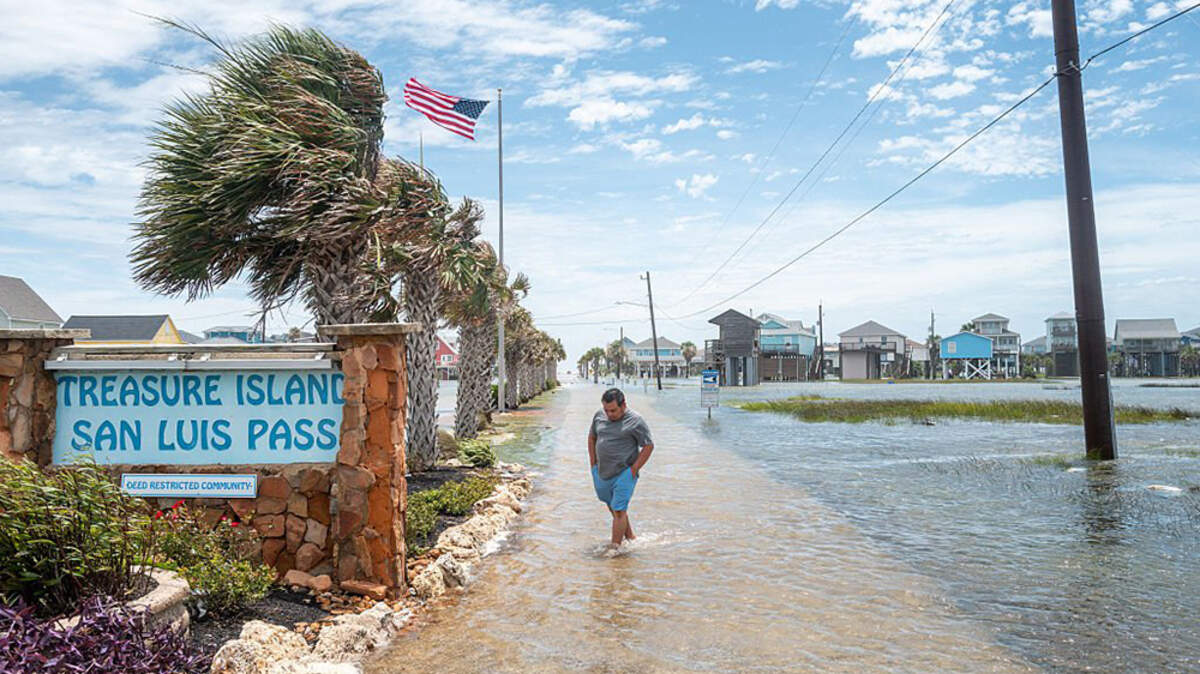 A person walks through a flooded neighborhood after Tropical Storm Arthur made landfall in Freeport, Texas, on Wednesday. Arthur became the first named storm of the Atlantic hurricane season but degenerated into a post-tropical cyclone late Wednesday, according to the National Hurricane Center.