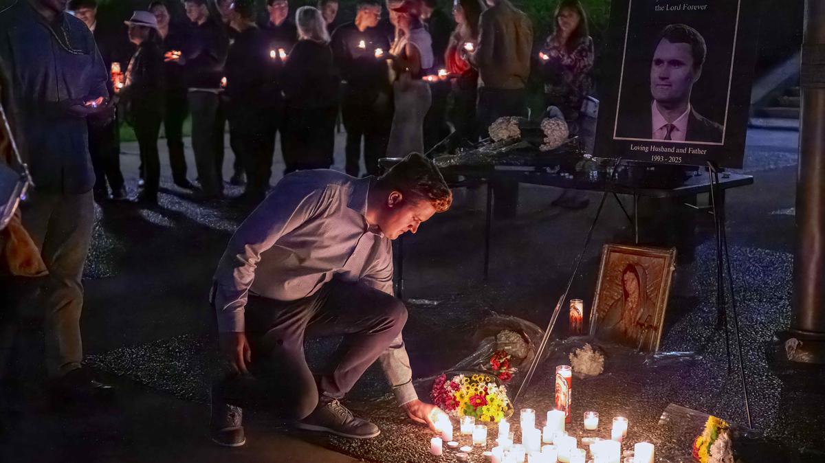 People line up to place a candle in honor of the life of Charlie Kirk during a vigil organized by UCI College Republicans on the campus of UC Irvine in Irvine on Thursday, Sept. 11, 2025.