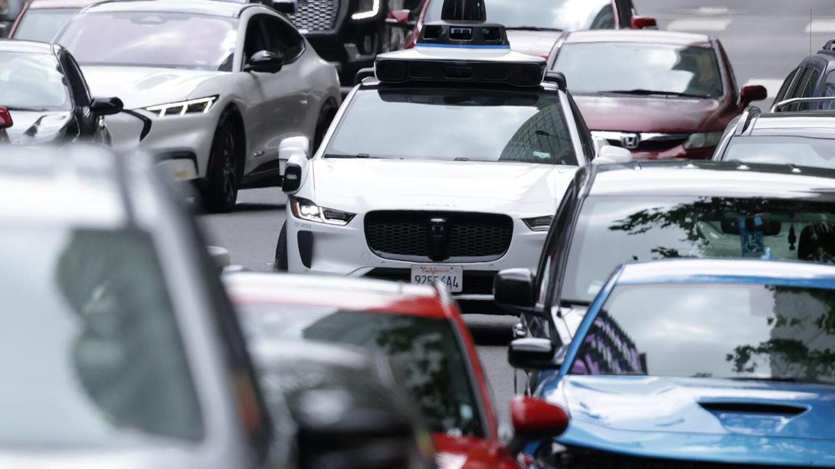 LOS ANGELES, CA - MAY 12, 2026: A Waymo sits in traffic on Figueroa Street in downtown Los Angeles, CA on Tuesday, May 12, 2026. (Myung J. Chun / Los Angeles Times)