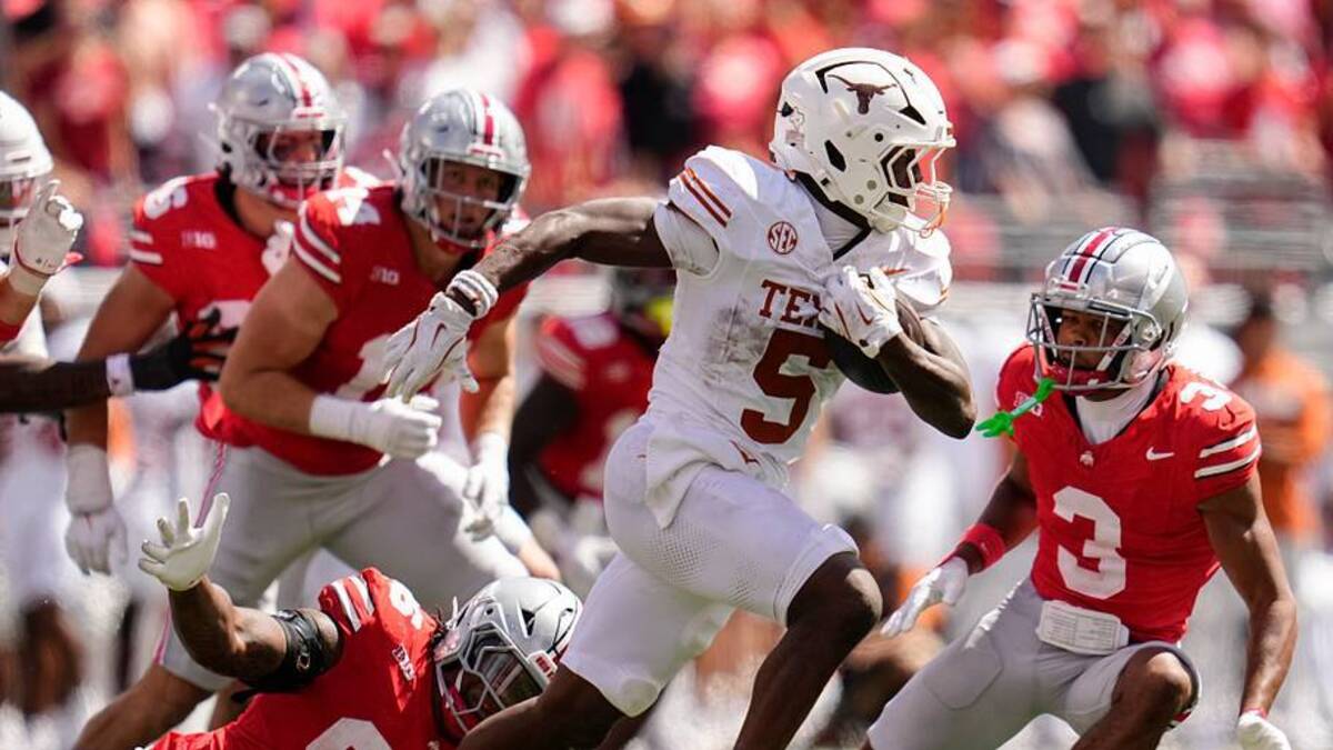  Texas Longhorns running back Quintrevion Wisner (5) runs past Ohio State Buckeyes defensive end Eddrick Houston (96) during the second half of the NCAA football game at Ohio Stadium on Aug. 30, 2025. Ohio State won 14-7. | USA TODAY Network via Reuters Connect 