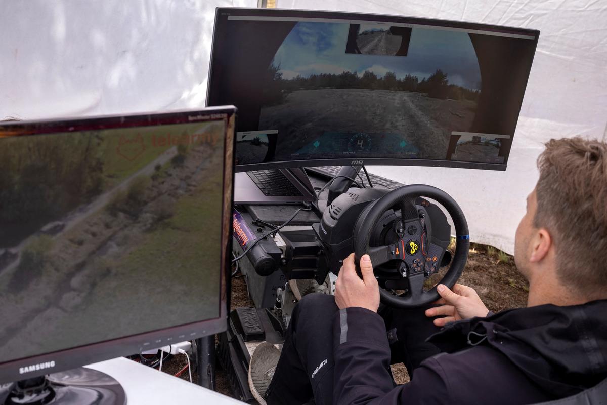 An man remote-controls a Soviet-era armoured vehicle that has been fitted with remote-driving capabilities by the Estonian company Telearmy at a defense technology event organized by the defence accelerator Defence Builder, amid Russia's attack on Ukraine, in an unspecified location in Ukraine, May 30, 2026. REUTERS/Thomas Peter