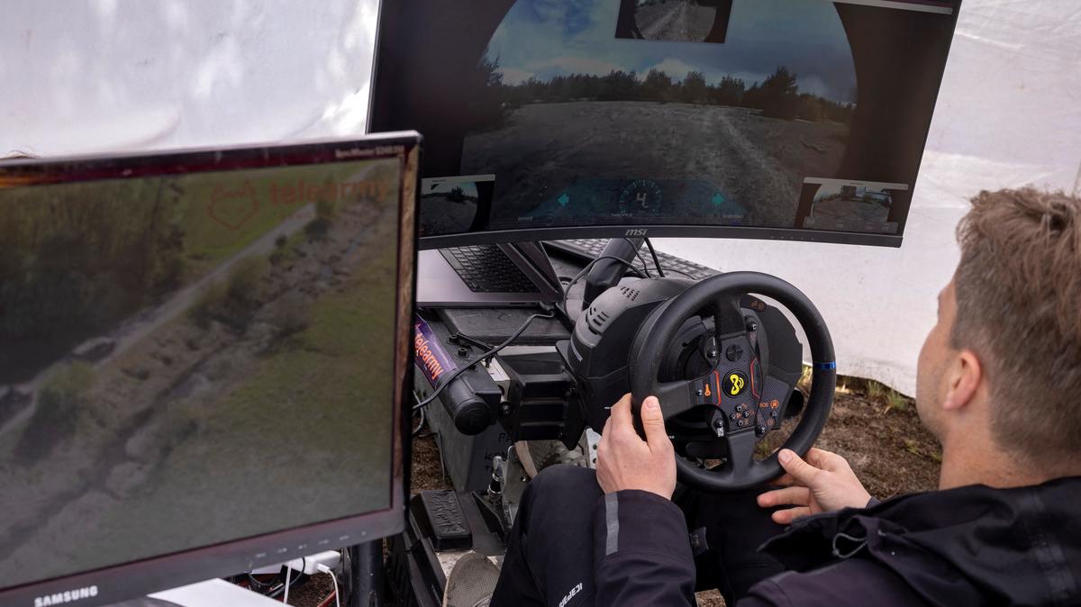 An man remote-controls a Soviet-era armoured vehicle that has been fitted with remote-driving capabilities by the Estonian company Telearmy at a defense technology event organized by the defence accelerator Defence Builder, amid Russia's attack on Ukraine, in an unspecified location in Ukraine, May 30, 2026. REUTERS/Thomas Peter