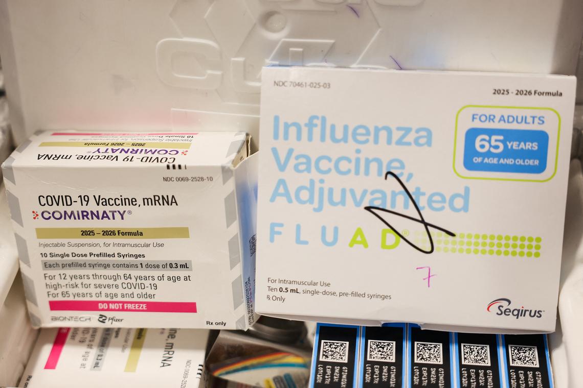 Boxes of the Pfizer-BioNTech COVID-19 vaccine and Seqirus Fluad adjuvanted flu shot.