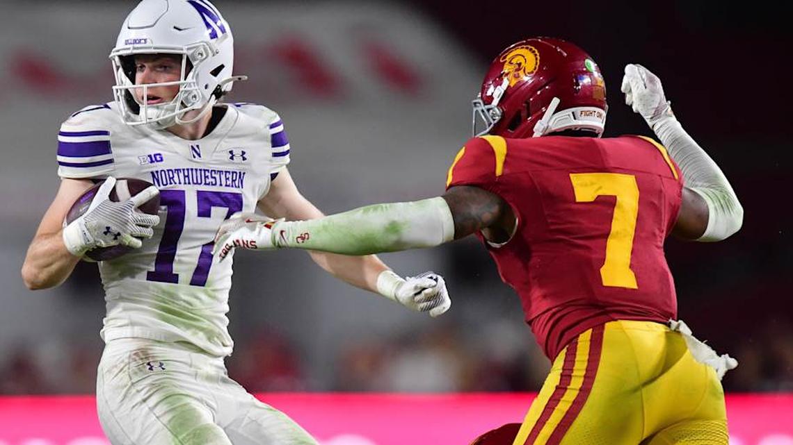  Nov 7, 2025; Los Angeles, California, USA; Northwestern Wildcats wide receiver Griffin Wilde (17) runs the ball against Southern California Trojans safety Kamari Ramsey (7) during the second half at the Los Angeles Memorial Coliseum. Mandatory Credit: Gary A. Vasquez-Imagn Images | Gary A. Vasquez-Imagn Images 