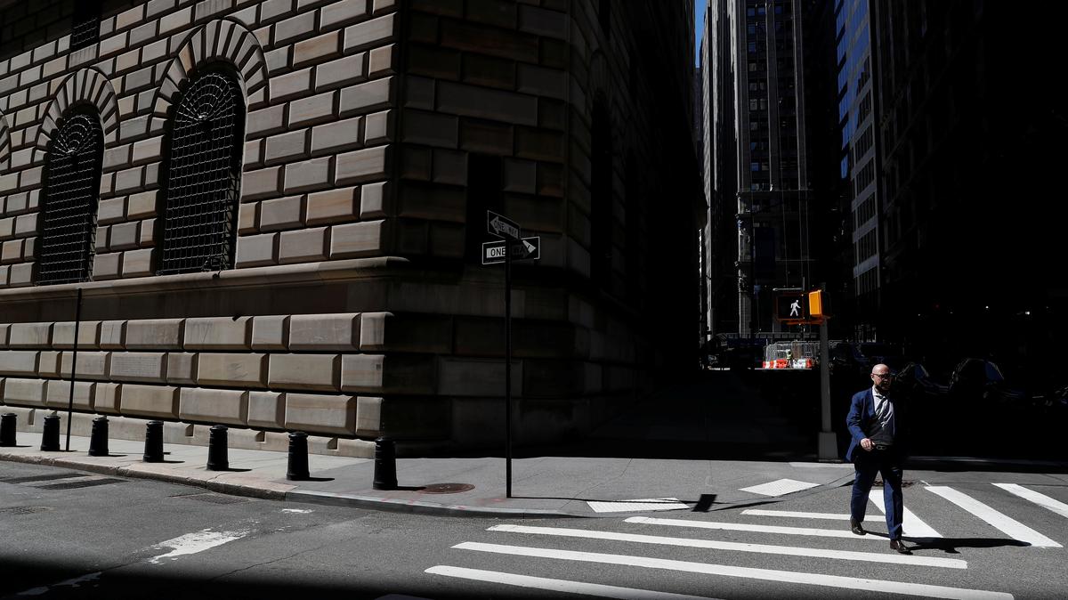 A man walks by the Federal Reserve Bank of New York Building in New York City, U.S., April 26, 2021. REUTERS/Shannon Stapleton