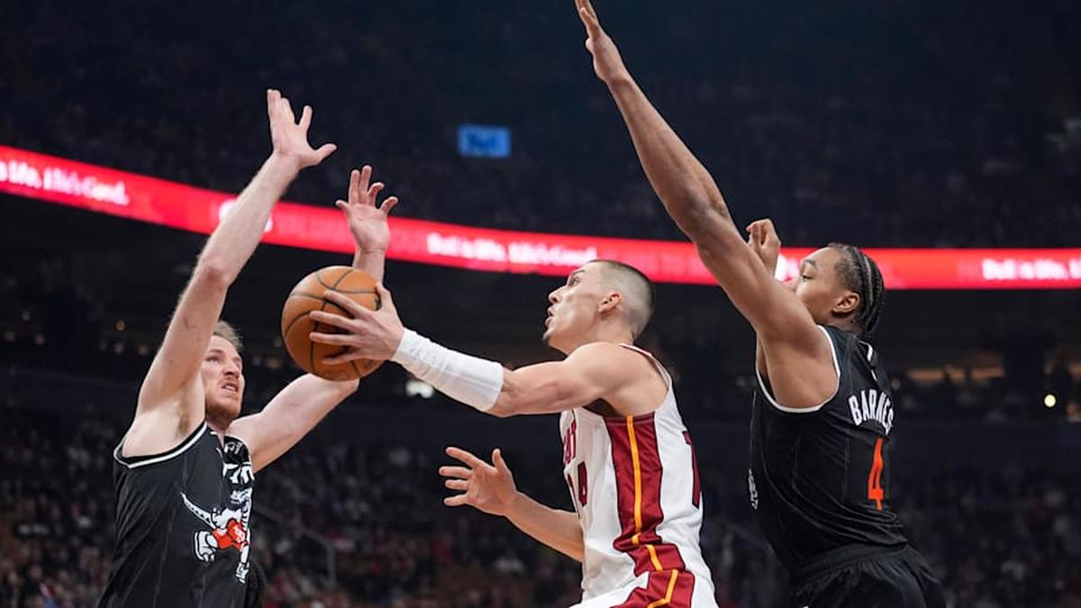  Apr 9, 2026; Toronto, Ontario, CAN; Miami Heat guard Tyler Herro (14) shoots the ball against Toronto Raptors center Jakob Poeltl (19) and guard Scottie Barnes (4) during the first half at Scotiabank Arena. Mandatory Credit: John E. Sokolowski-Imagn Images | John E. Sokolowski-Imagn Images 