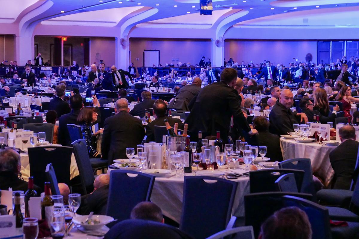  People take cover at the annual White House Correspondents Association Dinner on April 25, 2026, in Washington, D.C. 