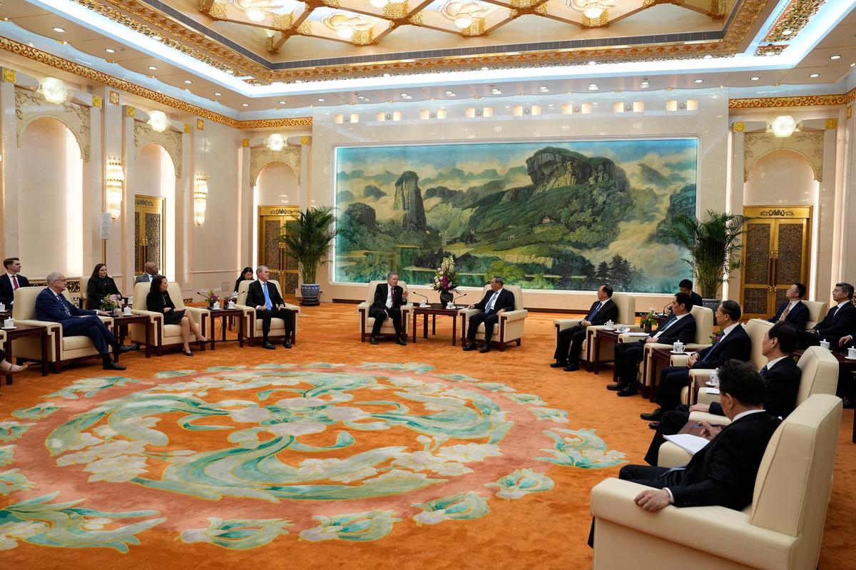 U.S. Senator Steve Daines, center left, talks to Chinese Premier Li Qiang, center right, during a meeting at the Great Hall of the People, in Beijing, Thursday, May 7, 2026.     Andy Wong/Pool via REUTERS