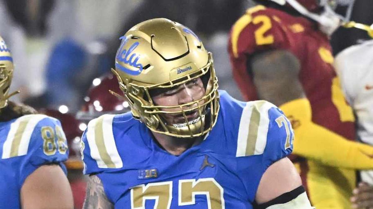  Nov 23, 2024; Pasadena, California, USA; UCLA Bruins tight end Moliki Matavao (88) and UCLA Bruins offensive lineman Garrett DiGiorgio (72) walks off the field USC Trojans head coach Lincoln Riley (far left) and bench celebrates in the closing minute at Rose Bowl. Mandatory Credit: Robert Hanashiro-Imagn Images | Robert Hanashiro-Imagn Images 