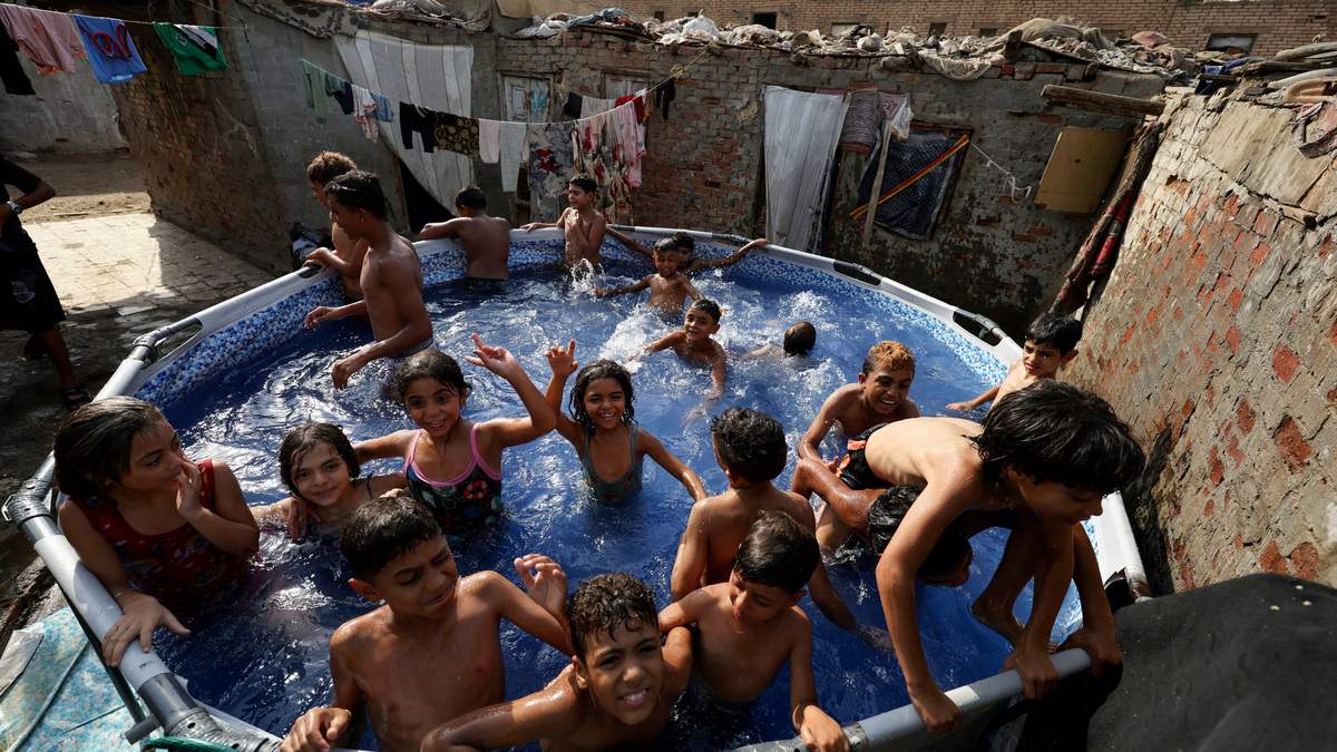 Children play in a portable swimming pool during a heat wave in Cairo on Aug. 11, 2025. Almost all of the world’s children are exposed to at least one climate hazard, with as many as 1.8 billion put in danger by droughts and 1.2 billion by extreme heat, UNICEF said in a report on Tuesday.
