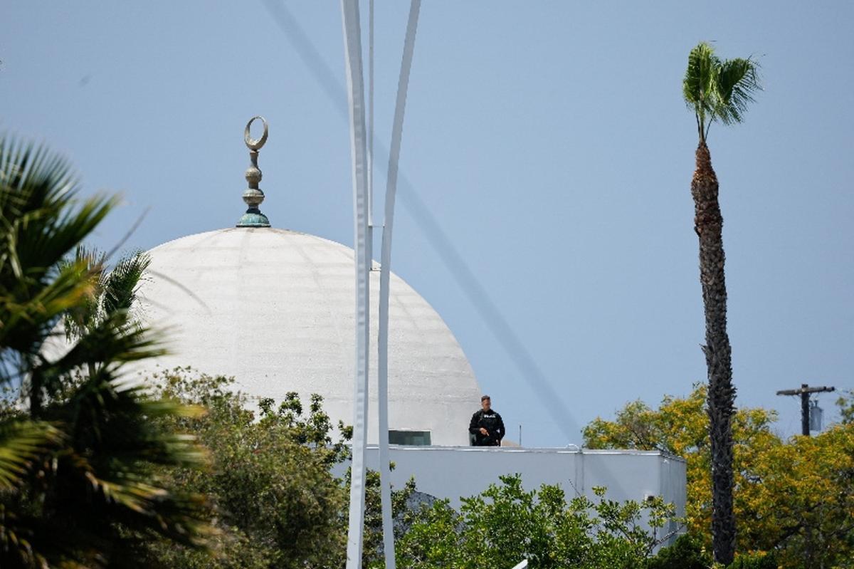 A police officer stands guard as emergency workers respond at the scene of a reported active shooter situation at the Islamic Center in San Diego, California, U.S., May 18, 2026.  REUTERS/Mike Blake