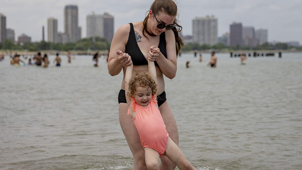 Taylor Cerle plays with her niece, Milana Miller, 2, in Lake Michigan during a heat wave on Monday at Chicago’s North Avenue Beach. Millions of people are facing dangerous and potentially record-breaking heat as a heat wave grips much of the central and eastern United States through the Fourth of July weekend.