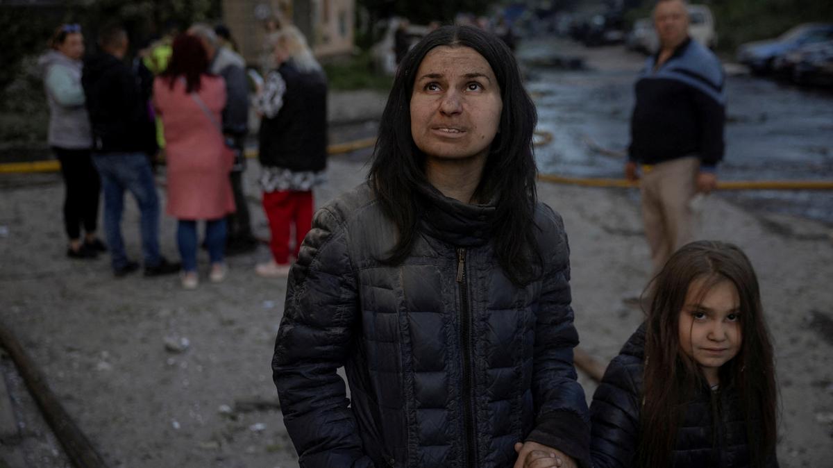 Resident Olha Mudra and her daughter Natalia, 6, look at their damaged apartment after a nearby building got struck during overnight Russian missile and drone attacks, amid Russia's attack on Ukraine, in Kyiv, Ukraine, June 2, 2026. REUTERS/Thomas Peter