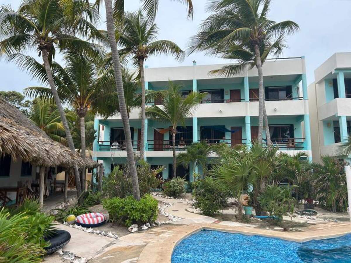  Hotel Villa Kiin features palm trees, a pool and colorful balconies overlooking lush gardens. Photo credit: Jennifer Merrick 