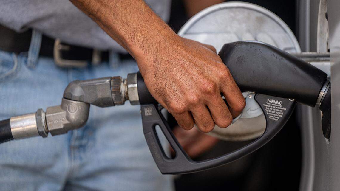 Guy Benhamou pumps gas at an Exxon Mobil gas station on June 9, 2022, in Houston. (Brandon Bell/Getty Images/TNS)