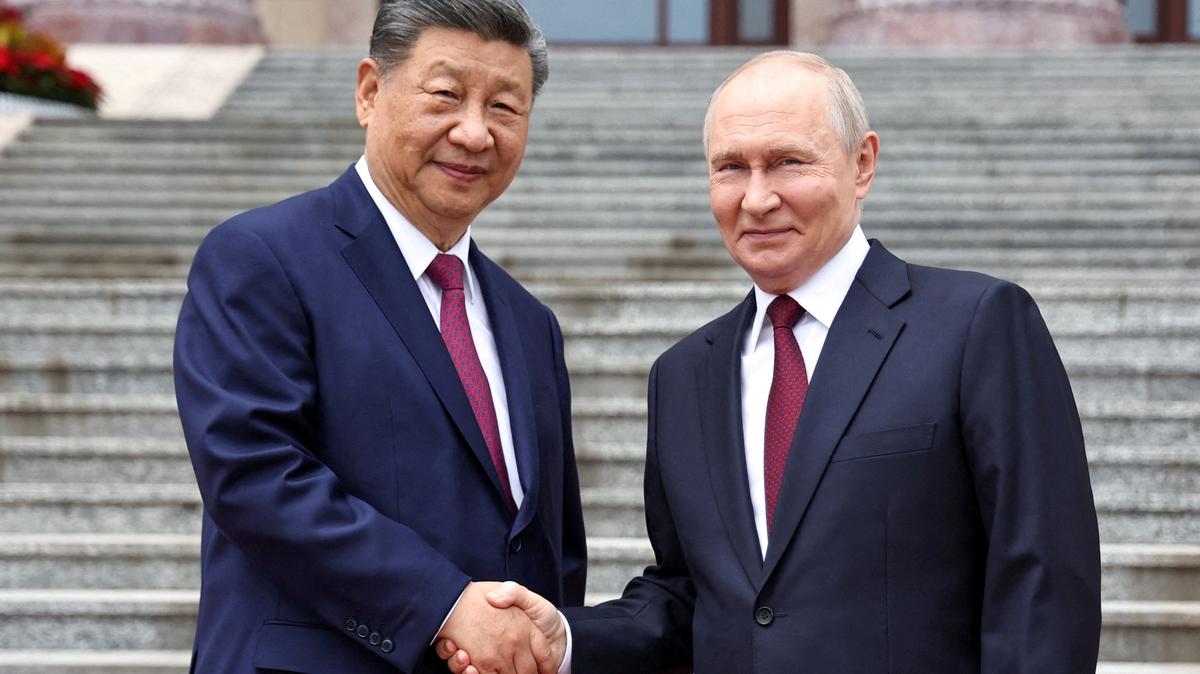 Russian President Vladimir Putin shakes hands with Chinese President Xi Jinping during a welcoming ceremony at the Great Hall of the People in Beijing, China May 20, 2026. Sputnik/Alexander Kazakov/Pool via REUTERS