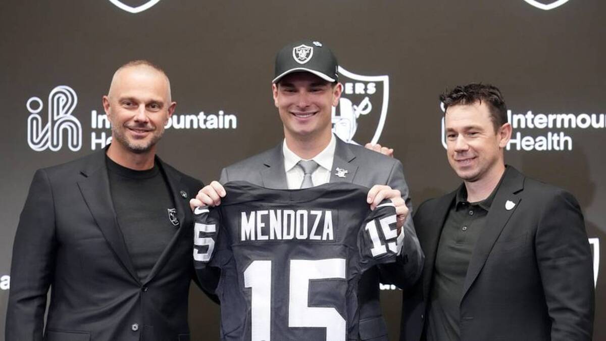  Apr 24, 2026; Henderson, NV, USA; Las Vegas Raiders quarterback Fernando Mendoza (center) poses with jersey with general manager John Spytek (left) and head coach Klint Kubiak at introductory press conference at Intermountain Health Performance Center after being selected as the No. 1 pick in the 2026 NFL Draft. Mandatory Credit: Kirby Lee-Imagn Images | Kirby Lee-Imagn Images 