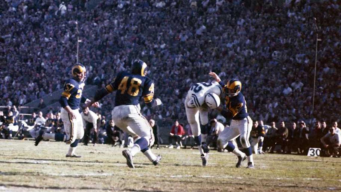  Dec 12, 1959; Los Angeles, CA, USA; FILE PHOTO; Baltimore Colts receiver Raymond Berry (82) catches a ball in front of Los Angeles Rams defensive backs Eddie Meador (21) at the Memorial Coliseum. Mandatory Credit: David Boss-Imagn Images | David Boss-Imagn Images 