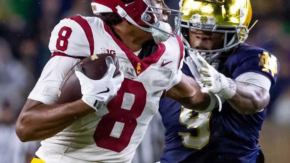  Oct 18, 2025; South Bend, Indiana, USA; Southern California Trojans wide receiver Ja'Kobi Lane (8) breaks a tackle by Notre Dame Fighting Irish safety Tae Johnson (9) during the second half at Notre Dame Stadium. Mandatory Credit: Michael Caterina-Imagn Images | Michael Caterina-Imagn Images 
