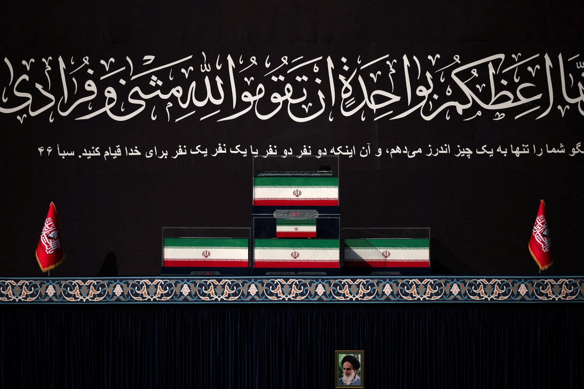 A portrait of late leader of the Islamic Revolution, Ayatollah Ruhollah Khomeini,  is displayed next to the coffins of Iran's late Supreme Leader Ayatollah Ali Khamenei and his family members, during a public farewell ceremony to pay their respects to Khamenei, who was killed on February 28 in Israeli and U.S. airstrikes, at the Imam Khomeini Grand Mosalla, in Tehran, Iran July 4, 2026.  REUTERS/Alkis Konstantinidis