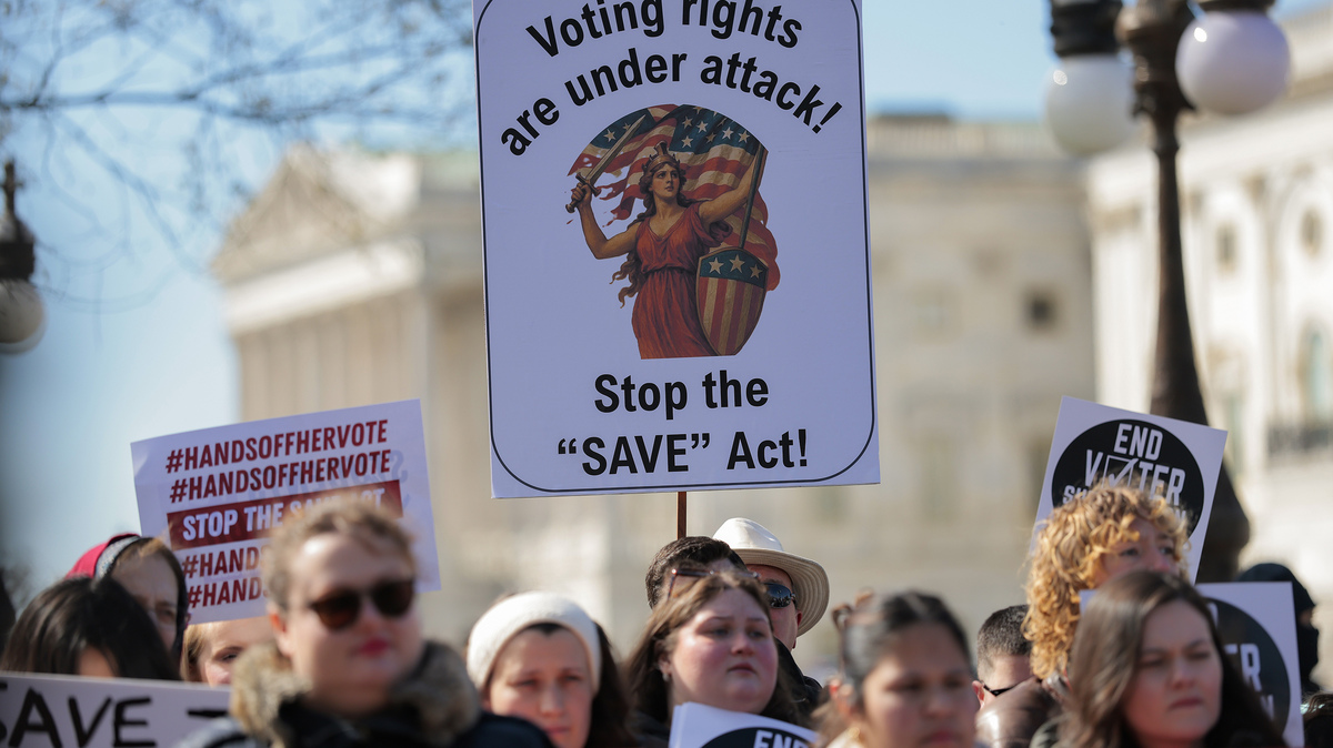 Attendees hold signs advocating for voting rights and against the SAVE America Act at a rally to outside the U.S. Capitol on March 18, 2026, in Washington, D.C. The SAVE Act would create a burden, especially for poor and marginalized voters, by requiring additional documentation to cast a ballot.