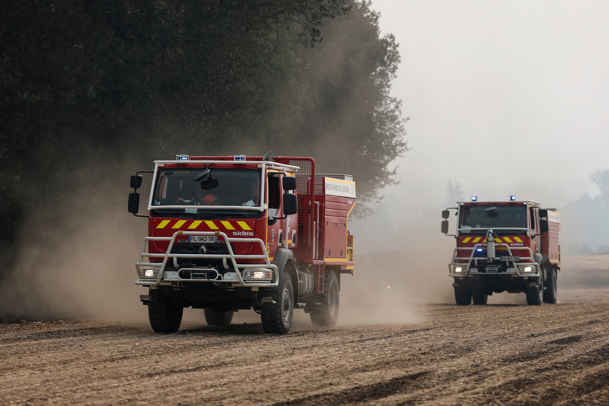 Fire trucks drive as French firefighters battle a wildfire in the Fontainebleau forest in Noisy-sur-Ecole near Paris, amid a heatwave affecting a large part of the country, France, July 13, 2026. REUTERS/Benoit Tessier